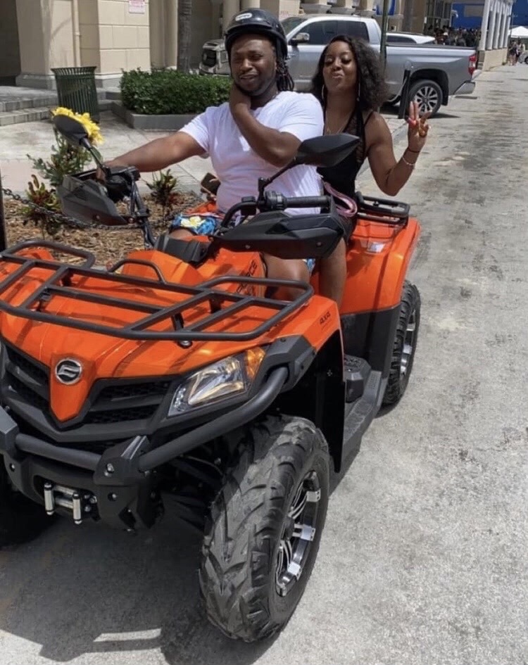 Couple riding an orange ATV in Nassau